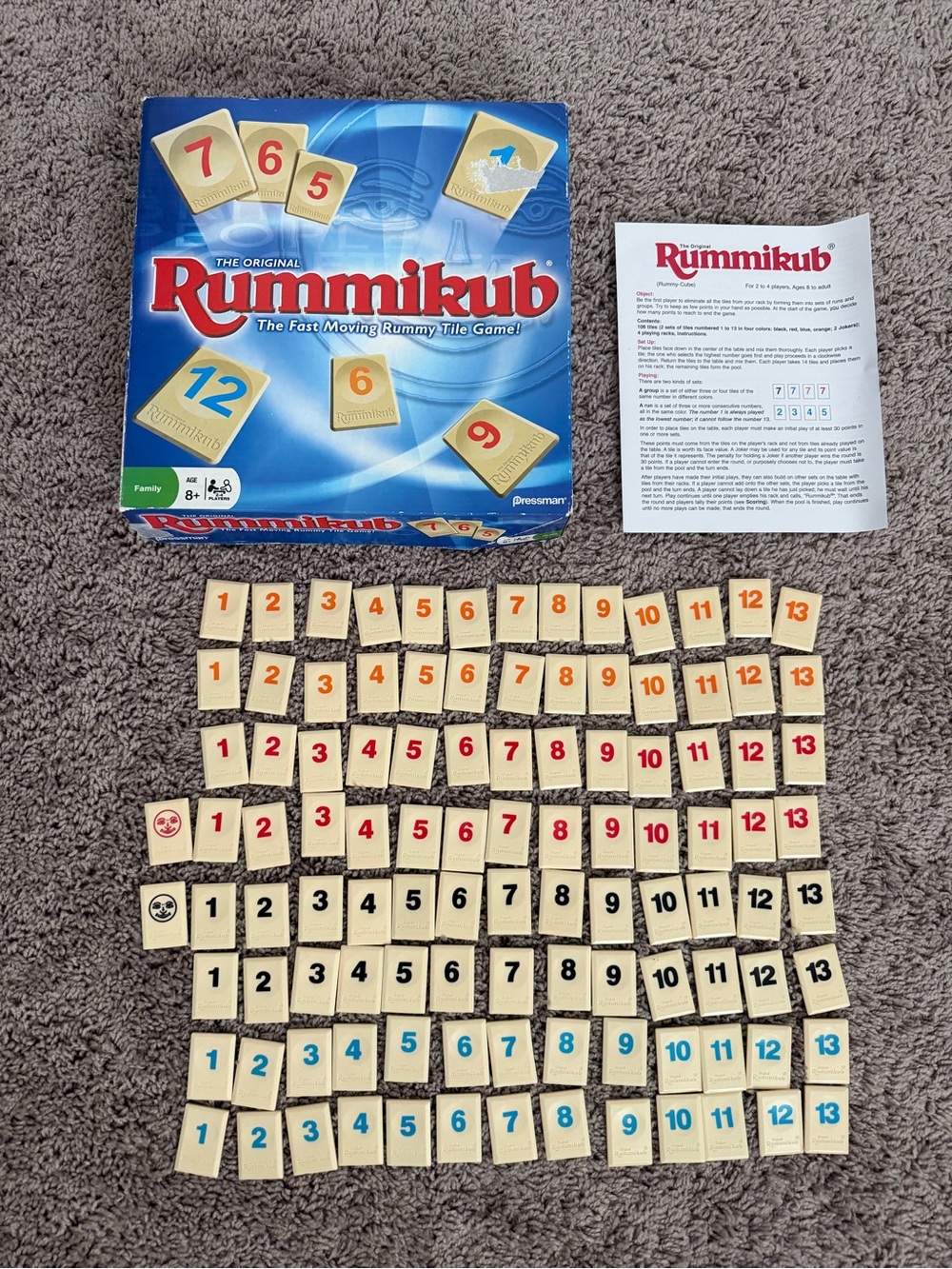 Rummikub Tile Game - Cream Tiles with Red, Black, Blue, and Orange Numbers
